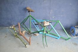 FIVE VINTAGE BICYCLE FRAMES AND A QUANTITY OF STEEL SPOKED WHEELS, some with tyres of various sizes,