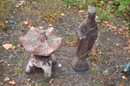 TWO ORIENTAL STYLE CONCRETE GARDEN ORNAMENTS, in the form of a small pagoda and a robed holy man,