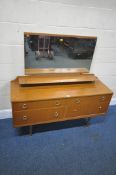 A MID-CENTURY TEAK DRESSING TABLE, with a rectangular mirror, a single shelf, over four drawers,