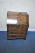 A 20TH CENTURY MAHOGANY BUREAU, the fall front door enclosing a fitted interior, above two short