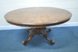 A BURR WALNUT OVAL TILT TOP TABLE, raised on a bulbous pedestal with four legs, with foliate and