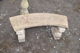 A CONCRETE CURVED GARDEN BENCH, with scrolled supports, width 127cm, Condition Report: some scores