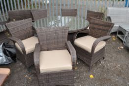 A RATTAN EFFECT GARDEN TABLE AND SIX CHAIRS, table diameter 134cm. Condition Report: some minor wear