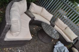 A RATTAN EFFECT CURVED GARDEN SET, with three curved sofas with adjoining tables, and a coffee table