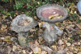 TWO CONCRETE BIRDBATHS both in the form of tree stumps with hollowed burr bowls one with squirrels
