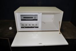 A LEAK STEREO 30 AMPLIFIER AND STEREOFETIC TUNER that's built in to a bespoke cabinet (PAT pass,