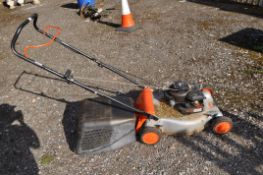 A FLYMO PETROL LAWN MOWER with grassbox (engine pulls freely but hasn't been started). Condition