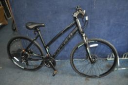 A CARRERA CROSSFIRE 2 LADIES BIKE in matt black with 24 speed Shimano gears, front and rear disc