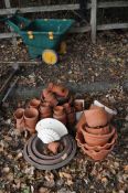 A COLLECTION OF TERRACOTTA AND OTHER PLANT POTS including a glazed wall hanging planter, a small