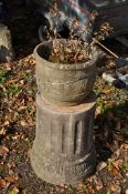 A ROUND CONCRETE PLANTER SAT ATOP A CORINTHIAN STYLE CONCRETE BASE total height 80cm