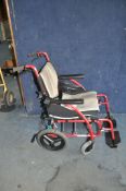 A KARMA ERGO 115 FOLDING WHEELCHAIR with two footrests