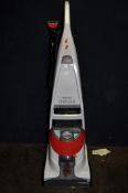 A BISSELL DELUXE UPRIGHT CARPET WASHER with upholstery attachment (PAT pass and working)