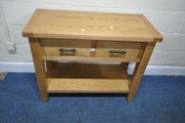 A MODERN LIGHT OAK SIDE TABLE, with two frieze drawers, raised on block legs, united by an
