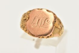 A BOXED GENTS YELLOW METAL SIGNET RING, engraved shield shape, with textured shoulders, on a