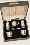 A CASED SILVER CRUET SET, to include a pair of pepperettes, mustard and two salts with blue glass