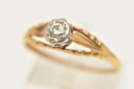 A YELLOW METAL SINGLE STONE DIAMOND RING, illusion set with a round brilliant cut diamond, estimated