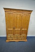 SCHREIBER, A MODERN PINE TRIPLE DOOR WARDROBE, with five assorted drawers, width 154cm x depth