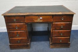 A 19TH CENTURY PITCH PINE DESK, with a green leatherette writing surface, twin pedestals, fitted