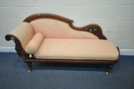 A VICTORIAN WALNUT CHAISE LOUNGE, with a scrolled frame and details, raised on turned legs with