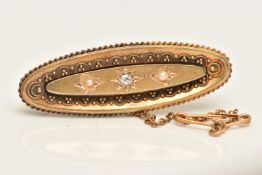 A 15CT GOLD PEARL AND DIAMOND BROOCH, an oval form brooch set with a central old cut diamond and two