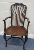 AN ART DECO CARVER CHAIR, the backrest with scrolled splats, swept open armrests, raised on front