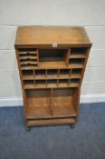 A 20TH CENTURY OAK POST OFFICE PIGEON HOLE CABINET, with a variety of divisions, raised on