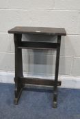 A 20TH CENTURY STAINED PINE PRIE DIEU PRAYER DESK, raised on trestle style legs, united by a bible