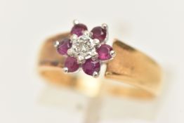 AN 18CT GOLD RUBY AND DIAMOND CLUSTER RING, of a flower shape, set with a central illusion set