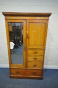 AN EARLY 20TH CENTURY OAK WARDROBE, with a single mirror door, a smaller door, and four assorted