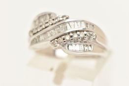 A MODERN 9CT GOLD DIAMOND RING, a cross over design ring set with baguette cut diamonds, tapered