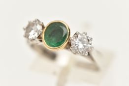 AN 18CT GOLD EMERALD AND DIAMOND THREE STONE RING, set with a central oval cut emerald, collet set
