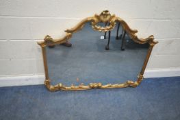 A REPRODUCTION ITALIAN ORNATE GILT RESIN OVERMANTEL MIRROR, with scrolled and foliate details, width