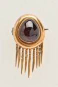 A VICTORIAN GARNET BROOCH, the garnet cabochon, within a plain polished surmount, suspending