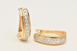 A BOXED PAIR OF YELLOW METAL DIAMOND SET HOOP EARRINGS, each earring of an oval form, set with a row