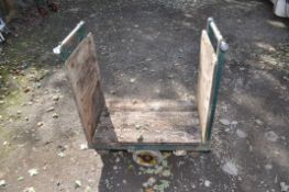 A VINTAGE WILMOT TRUCKS TROLLEY with still construction and later pine boarding, length 84cm