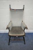 AN EARLY 20TH CENTURY MAHOGANY ARMCHAIR, with two finials, scrolled armrests, raised on splayed