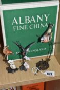 THREE ALBANY CHINA BIRD STUDIES comprising a Chaffinch perched on a bronzed thorny stand, height