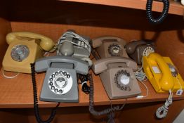 A GROUP OF TELEPHONES, comprising a yellow-orange 1980s rotary telephone, marked verso '810 OR