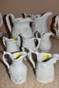 SEVEN PORTMEIRION PARIAN WARE JUGS, relief moulded with classical scenes, floral designs, hunting