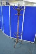 A 20TH CENTURY COAT / HAT STAND, the rotating top with six scrolled arms, height 184cm, condition