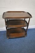 LUCIAN ERCOLANI, AN ERCOL MID-CENTURY DARK ELM THREE TIER TEA TROLLEY, each tier with raised