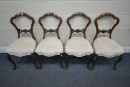 A SET OF FOUR VICTORIAN CHAIRS, with shaped backrest, serpentine front seats, raised on front