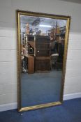 A LARGE GILT WOOD RECTANGULAR BEVELLED EDGE WALL MIRROR, 196cm x 104cm, condition report: general