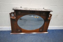 AN ART NOUVEAU WALNUT OVERMANTEL MIRROR, with an oval bevelled plate, surrounded by four copper