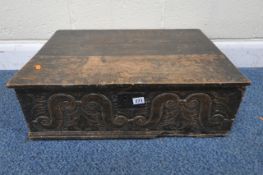 A GEORGIAN OAK BIBLE BOX, with a hinged lid, scrolled and foliate carvings to the front, width