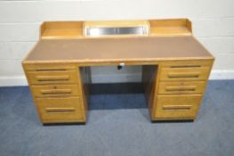 AN EARLY 20TH CENTURY OAK DESK, the raised back with a central hinged compartment, raised on twin