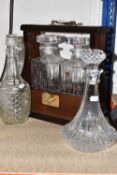 A TANTALUS AND FOUR DECANTERS to include a tantalus with a pull down side with two RCR whisky
