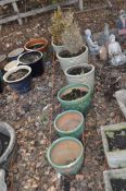 SIX GLAZED GARDEN POTS, comprising two sets of three, one set with ribbed sides, the largest two