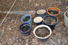 A COLLECTION OF EIGHT GARDEN POTS, including blues, greens and browns, the largest being 39cm in