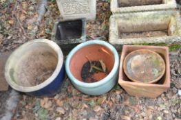 A COLLECTION OF GLAZED AND TERRACOTTA PLANT POTS, including two round and one tapered glazed pot,